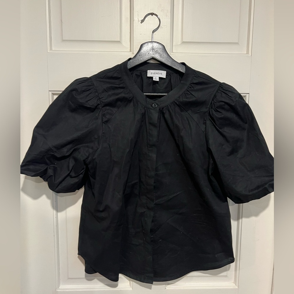Black Short sleeved blouse with covered buttons and puff sleeves.